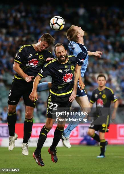 Dylan Fox and Andrew Durante of Wellington Phoenix compete with Matthew Simon of Sydney FC during the round 19 A-League match between Sydney FC and...