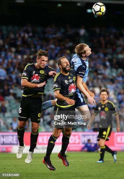 Dylan Fox and Andrew Durante of Wellington Phoenix compete with Matthew Simon of Sydney FC during the round 19 A-League match between Sydney FC and...