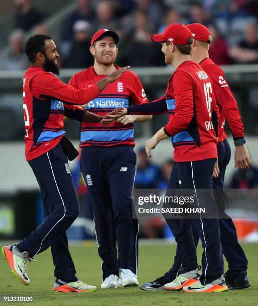 England's spin bowler Adil Rashid celebrates his wicket of Australia's Prime minister's XI batsman James Faulkner during their Twenty20 cricket match...