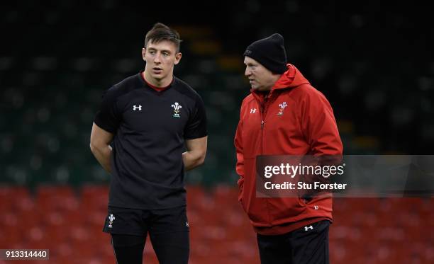 Wales debuatant Josh Adams chats with coach Neil Jenkins during the captain's run ahead of their opening Six Nations match against Scotland at...