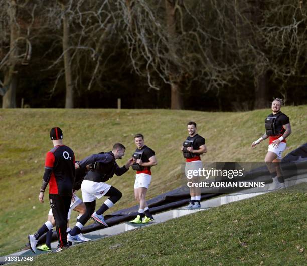 England's wing Jonny May runs up steps during a team training session at Pennyhill Park in Bagshot, some 40 miles west of London on February 2, 2018....