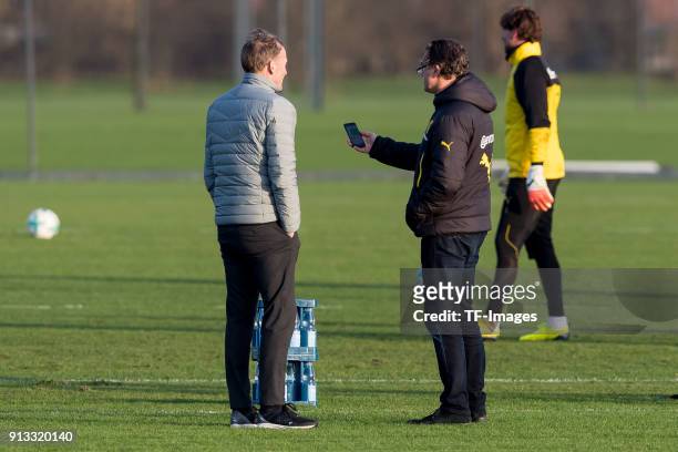 Hans-Joachim Watzke of Dortmund speaks with Sporting director Michael Zorc of Dortmund during a training session at BVB trainings center on January...
