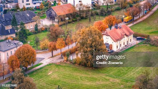 a local house at the middle of green field from aerial view on the roof of hohensalzburg fortress in the city of salzburg, austria during autumn - giardini di mirabell foto e immagini stock