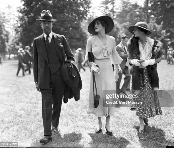 American military officer and engineer Cornelius Vanderbilt III and socialites Betty Gilbert Dickinson , and Gertrude Peabody Widener walk together...