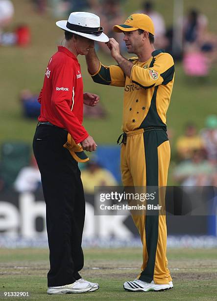 Ricky Ponting of Australia assists umpire Billy Bowden during the ICC Champions Trophy 1st Semi Final match between Australia and England played at...