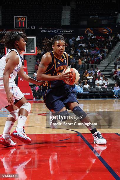 Tan White of the Connecticut Sun drives the ball against Ivory Latta of the Atlanta Dream during the WNBA game on September 11, 2009 at Philips Arena...