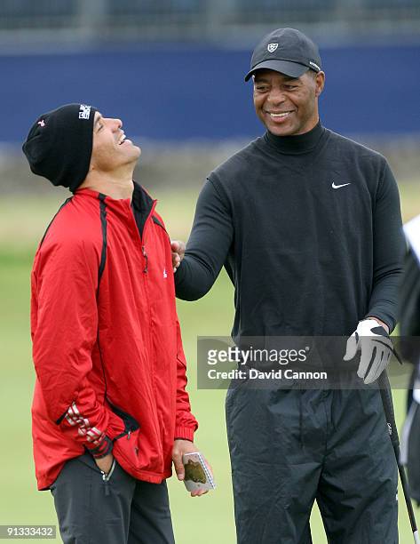 American football legend Marcus Allen shares a joke with Kelly Slater during the second round of The Alfred Dunhill Links Championship at The Old...