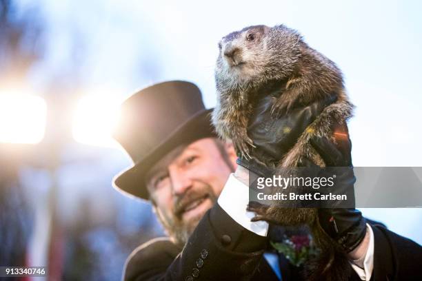 Punxsutawney Phil is held up by his handler for the crowd to see during the ceremonies for Groundhog day on February 2, 2018 in Punxsutawney,...