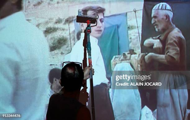 Worker prepares the exhibition of US Photographer Susan Meiselas at the Jeu de Paume museum on February 2 in Paris. / AFP PHOTO / ALAIN JOCARD /...