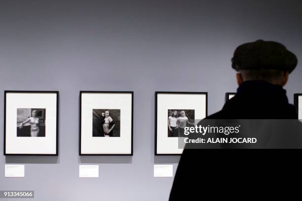 Man looks at pictures of US Photographer Susan Meiselas at the Jeu de Paume museum on February 2 in Paris. / RESTRICTED TO EDITORIAL USE - MANDATORY...