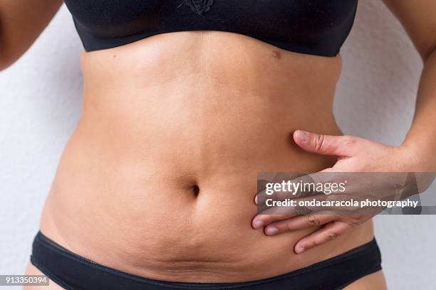 a woman waist with overweight - human abdomen foto e immagini stock