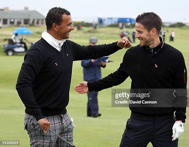 Football coach Ruud Gullit and football pundit Jamie Redknapp pat each other on the back on the 17th tee during the second round of The Alfred...