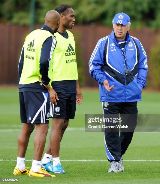 Chelsea manager Carlo Ancelotti talks to Didier Drogba and Nicolas Anelka during a training session the Cobham training ground on October 2, 2009 in...