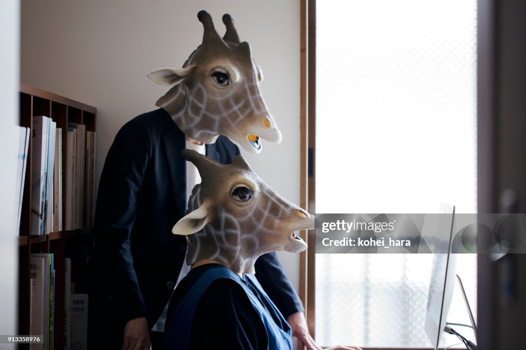 Giraffe heads man and woman working from home