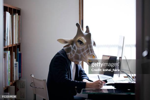 giraffe head man working from home - working from home funny stock pictures, royalty-free photos & images