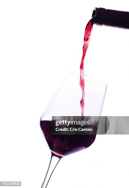 red wine pouring into glass - empty wine glass stock pictures, royalty-free photos & images