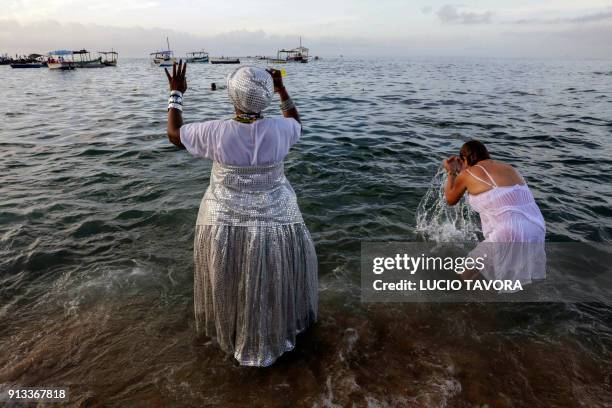 Faithfuls pray to Yemanja, the goddess of the sea from the ancient Yoruba mythology and one of the most popular deities of the Afro-Brazilian...