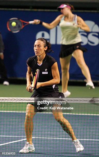 Francesca Schiavone of Italy and Alisa Kleybanova of Russia to return a shot in their doubles match against Cara Black of Zimbabwe and Liezel Huber...