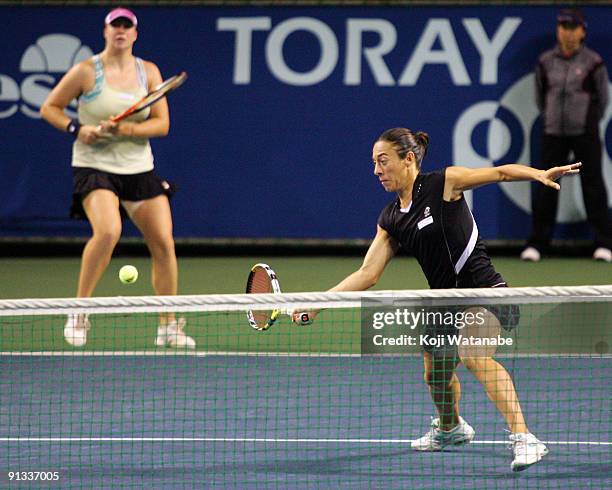 Francesca Schiavone of Italy and Alisa Kleybanova of Russia to return a shot in their doubles match against Cara Black of Zimbabwe and Liezel Huber...