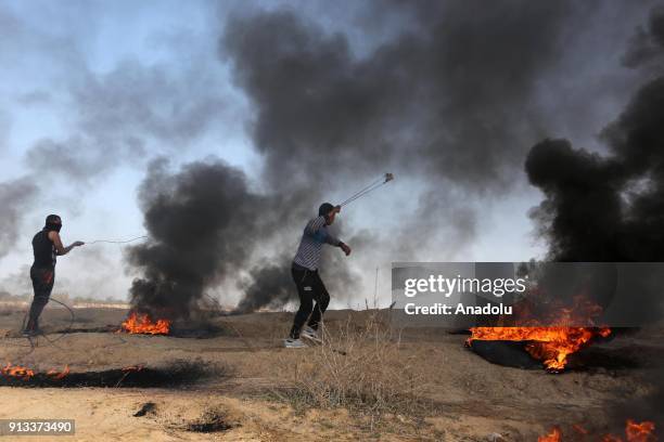 Palestinian protesters burn tyres in response to Israeli security forces' intervention during a protest against U.S. President Donald Trumps...