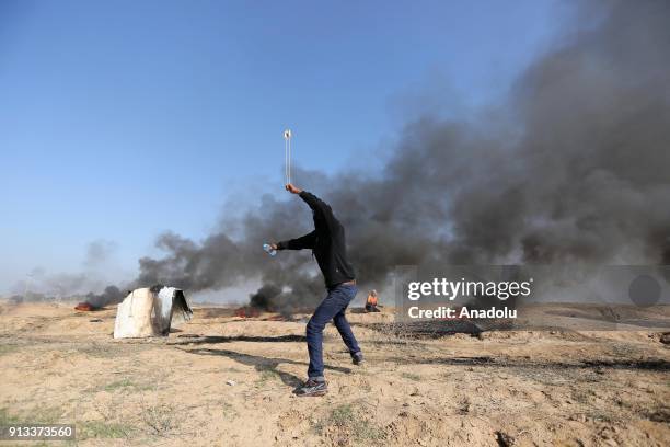 Palestinian protesters burn tyres in response to Israeli security forces' intervention during a protest against U.S. President Donald Trumps...