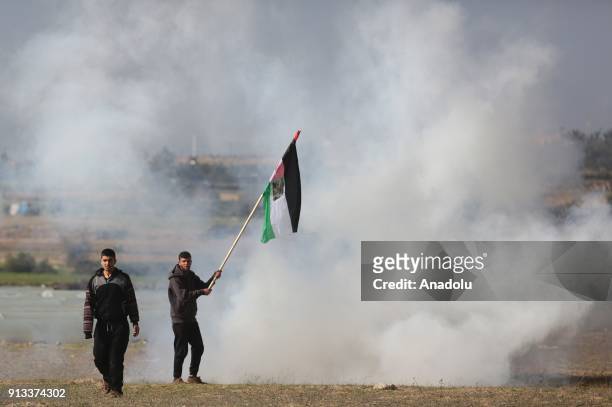 Palestinian protesters burn tyres in response to Israeli security forces' intervention during a protest against U.S. President Donald Trumps...