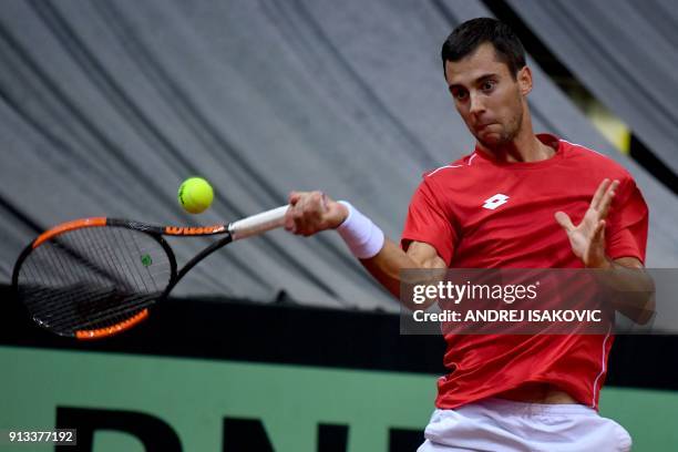 Serbia's Laslo Djere returns the ball to US tennis player Sam Querrey during the Davis Cup World Group first round single match between Serbia and...