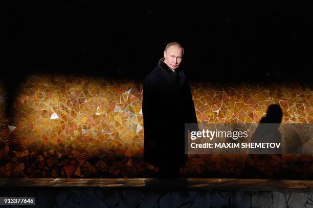 Russian President Vladimir Putin walks as he attends a wreath laying ceremony at the eternal flame of the Mamayev Kurgan memorial complex in the city...