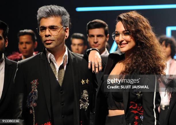 Indian Bollywood film director Karan Johar and actress Sonakshi Sinha showcase creations by designer Falguni Shane Peacock at the Lakmé Fashion Week...