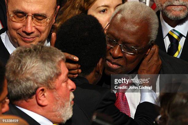 Brazilian football legend Pele is hugged by IAAF President Lamine Diack after Rio De Janeiro won the vote to host the 2016 Olympic Games at the Bella...
