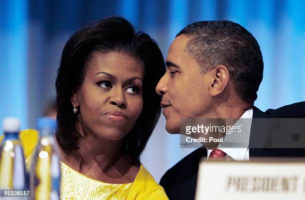 President Barack Obama has a word with first lady Michelle Obama after they arrive to make a presentation in support of Chicago as the host city for...