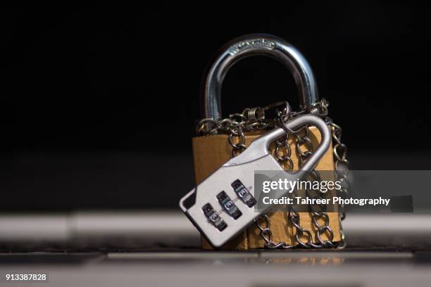 a lock placed on computer keyboard locked with chain and number lock - chain lock stock pictures, royalty-free photos & images