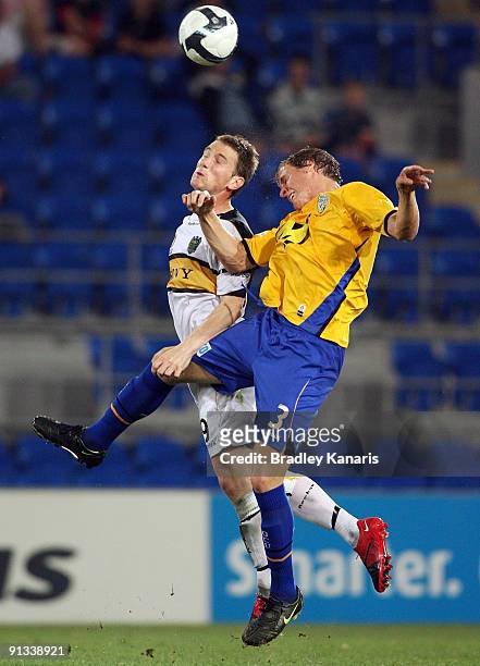 Michael Thwaite of United and Chris Greenacre of the Phoenix jump for a header during the round nine A-League match between Gold Coast United and the...