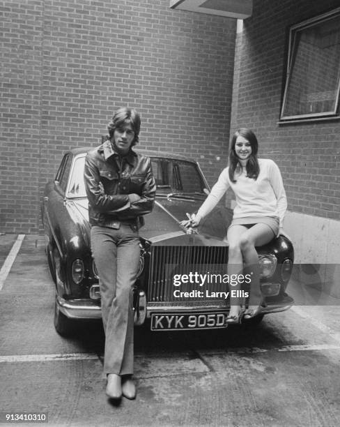 British singer-songwriter Barry Gibb and his girlfriend Linda Gray sit on Gibb's Roll Royce, UK, 28th October 1968.