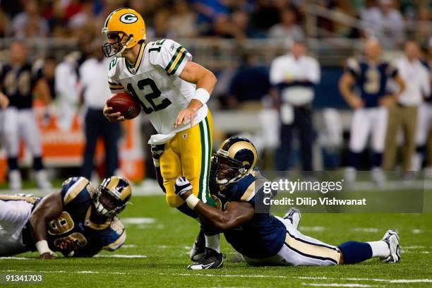 Aaron Rodgers of the Green Bay Packers scrambles against Leonard Little of the St. Louis Rams during the game at the Edward Jones Dome on September...