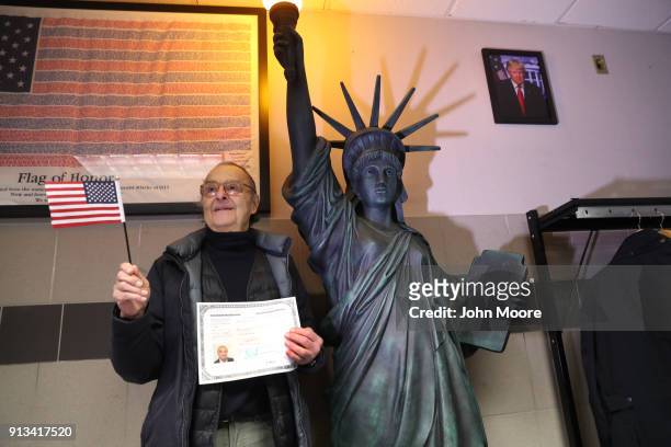 New American citizen poses for photos following a naturalization ceremony on February 2, 2018 in New York City. U.S. Citizenship and Immigration...