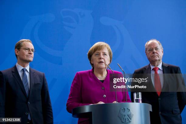 Berlin's Mayor Michael Mueller, German Chancellor Angela Merkel and former Finance Minister Peer Steinbrueck are pictured during the presentation of...