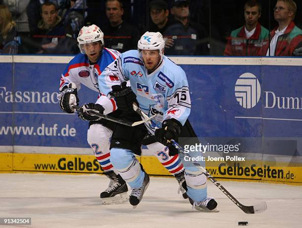Francois Fortier of Hamburg and Alain Nasreddine of Nuernberg fight for the puck during the DEL match between Hamburg Freezers and Nuernberg Ice...