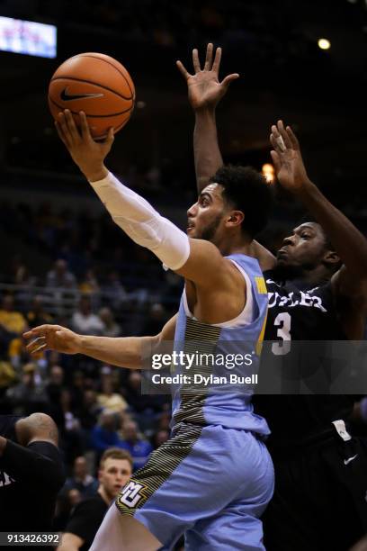 Markus Howard of the Marquette Golden Eagles attempts a shot while being guarded by Kamar Baldwin of the Butler Bulldogs in the first half at the...