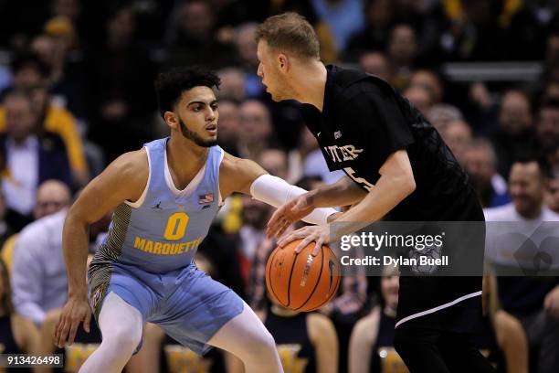 Paul Jorgensen of the Butler Bulldogs dribbles the ball while being guarded by Markus Howard of the Marquette Golden Eagles in the first half at the...