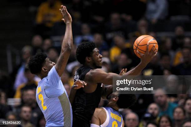 Kamar Baldwin of the Butler Bulldogs attempts a shot between Sacar Anim and Markus Howard of the Marquette Golden Eagles in the first half at the...