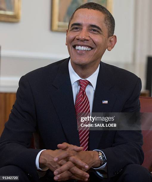 President Barack Obama smiles during meetings with Danish Prime Minister Lars Loekke Rasmussen in the Prime Minister's Office at the Christiansborg...