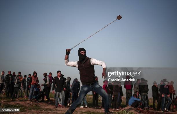 Palestinian protesters throw stones in response to Israeli security forces' intervention during a protest against U.S. President Donald Trumps...