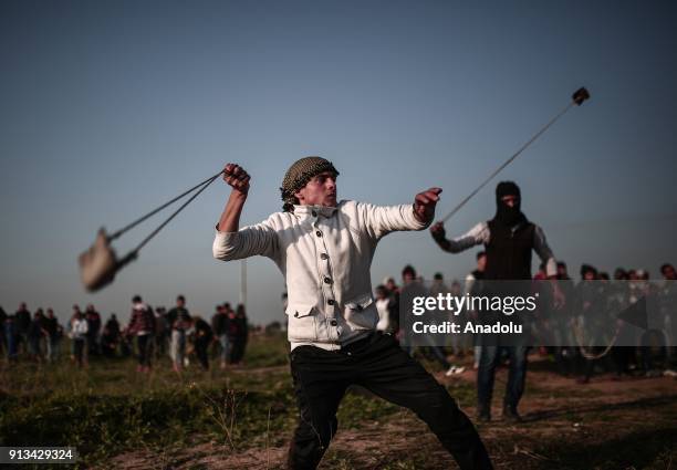 Palestinian protesters throw stones in response to Israeli security forces' intervention during a protest against U.S. President Donald Trumps...