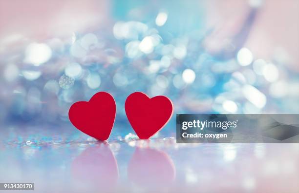 two heart shapes with bokeh background for valentines day - fahrradlampe stock-fotos und bilder