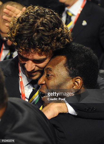 Pele hugs Brazilian tennis player Gustav Kuertin as members and supporters of the Rio Olympic bid celebrate winning the vote to host the 2016 Olympic...