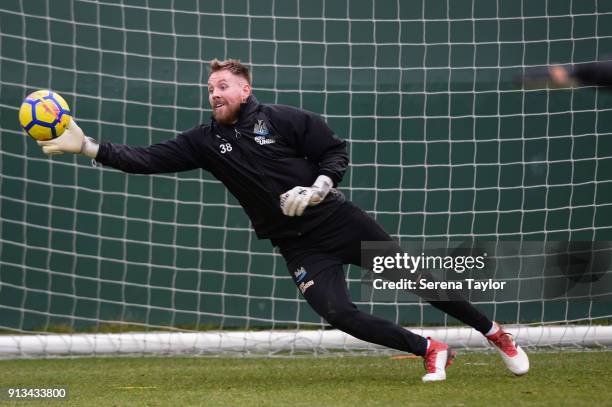 Goalkeeper Rob Elliot lunges to save the ball during the Newcastle United Training session at the Newcastle United Training Centre on February 2 in...