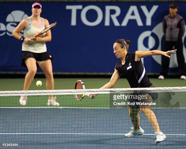 Francesca Schiavone of Italy and Alisa Kleybanova of Russia to return a shot in their doubles match against Cara Black of Zimbabwe and Liezel Huber...