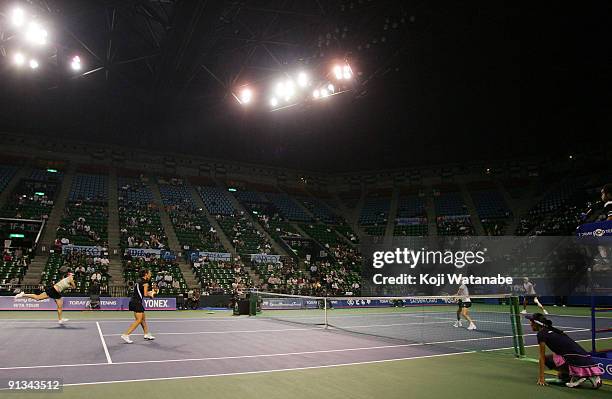 Francesca Schiavone of Italy and Alisa Kleybanova of Russia to return a shot in their doubles match against Cara Black of Zimbabwe and Liezel Huber...