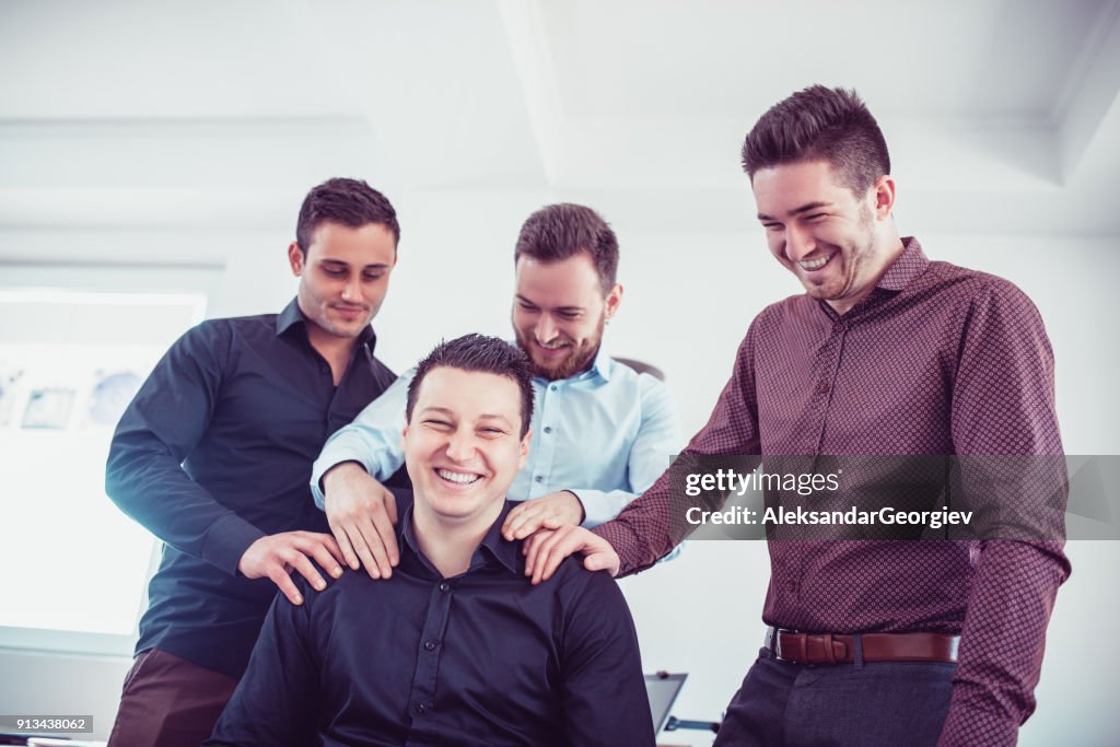 Group of Young Coworkers Making Fun of Colleague in Office